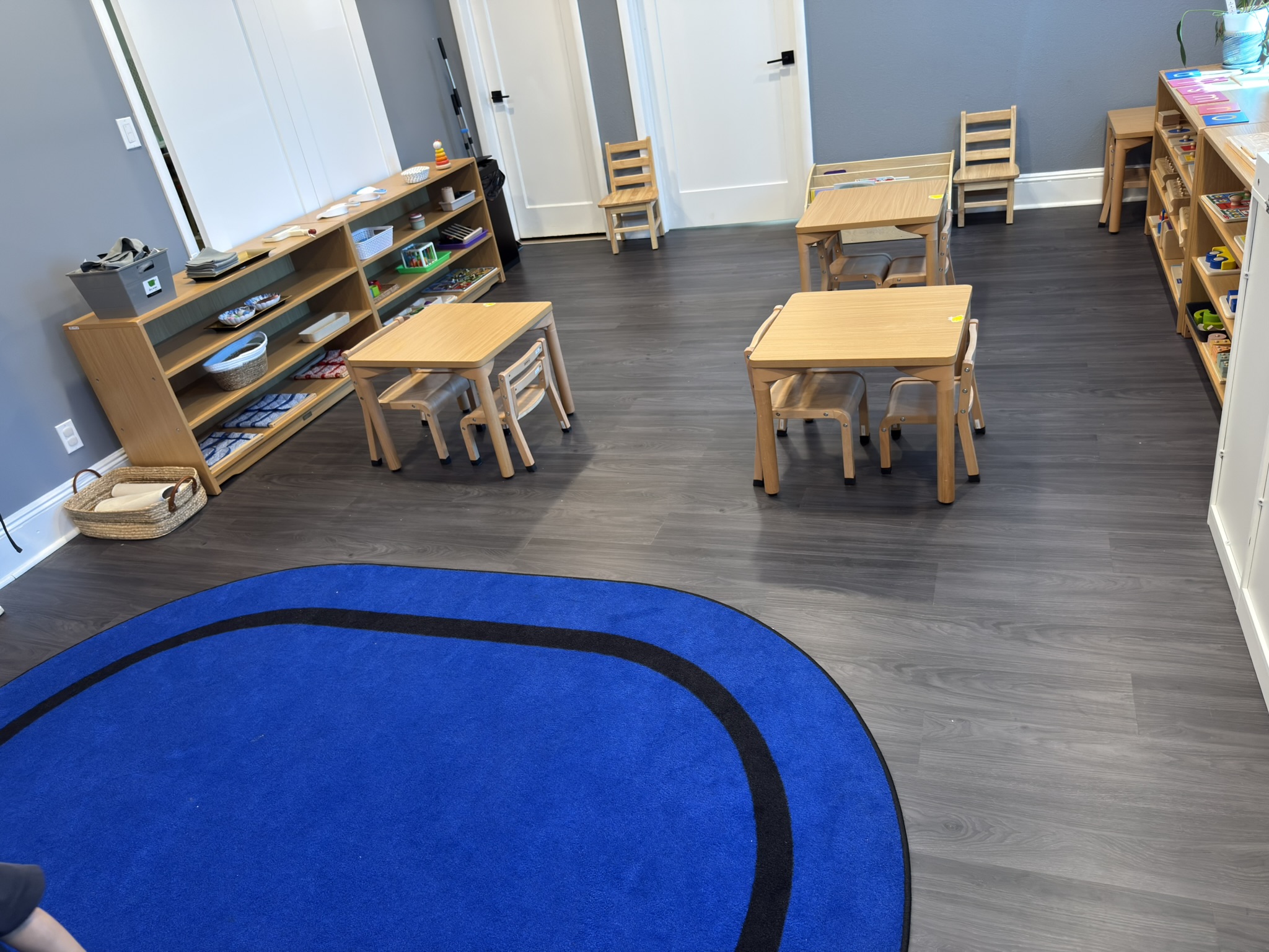 Montessori classroom with blue gathering rug